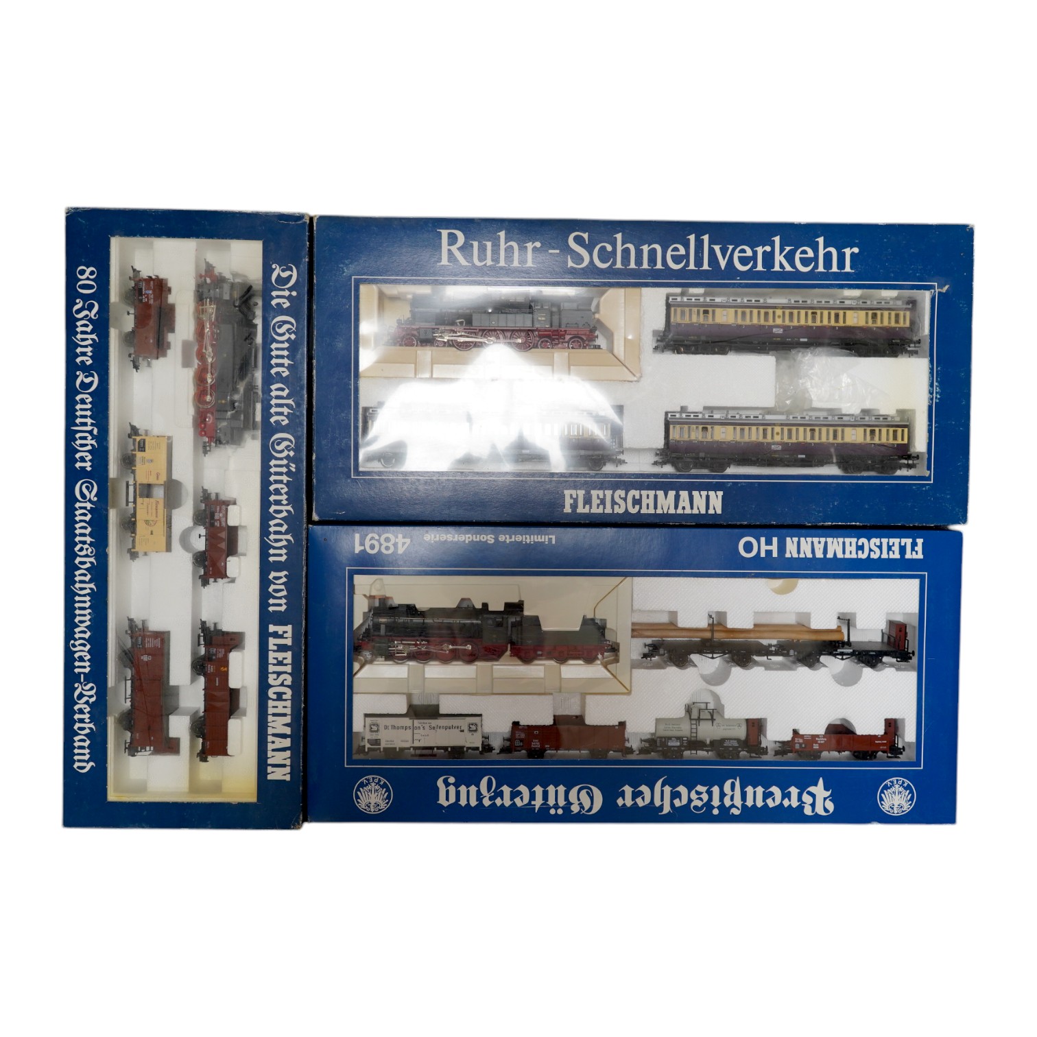 Three boxed Fleischmann HO gauge railway train sets; a passenger set with a 4-6-4T Loco and three clerestory coaches (4887), and two goods train sets, both comprising of a locomotive and an assortment of freight wagons (